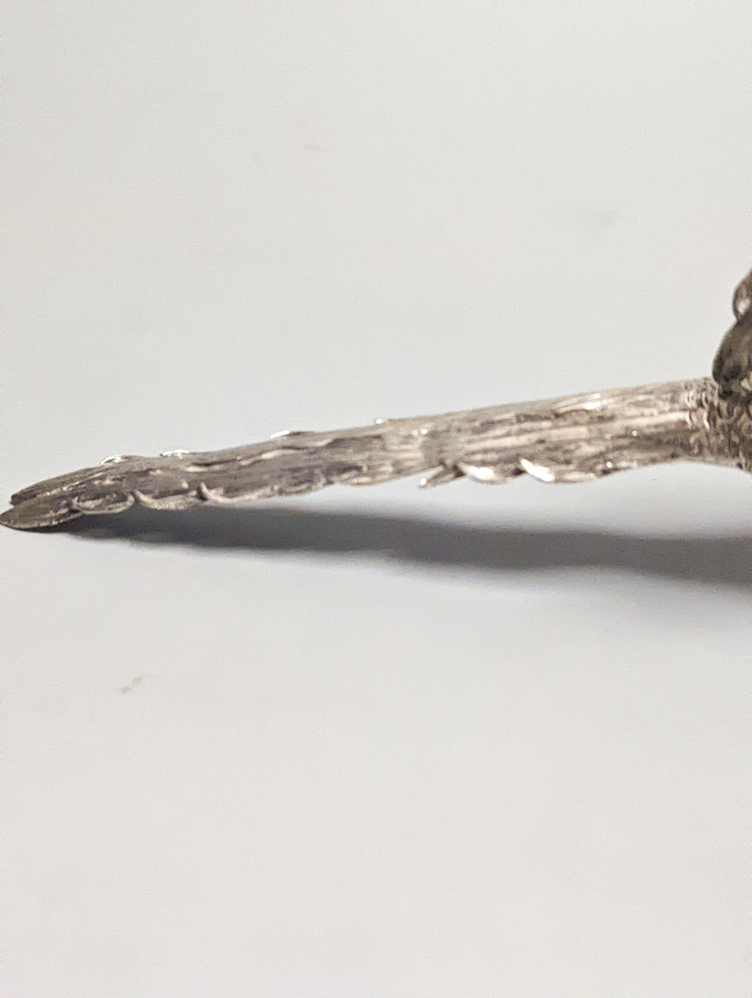 A late 19th century Hanau 800 white metal novelty condiment?, modelled as a game bird, with articulated wings and removable head, 22.4cm, gross 139 grams.